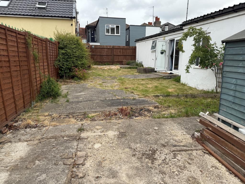 Lot: 161 - DETACHED BUNGALOW IN TOWN CENTRE - View of garden from rear showing lawn and patio